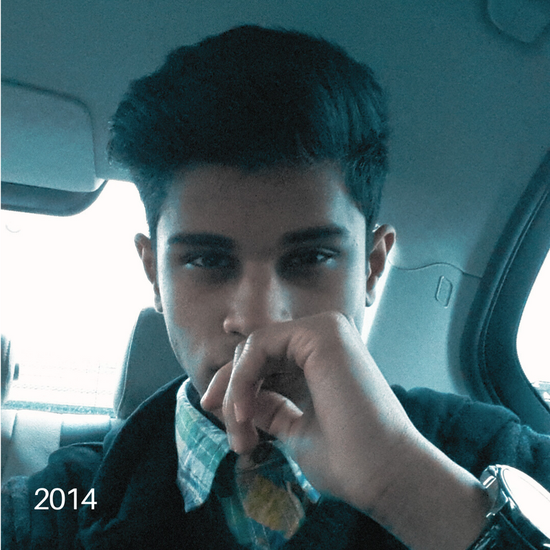 Sach in 2014, sitting in a car, hand resting on chin